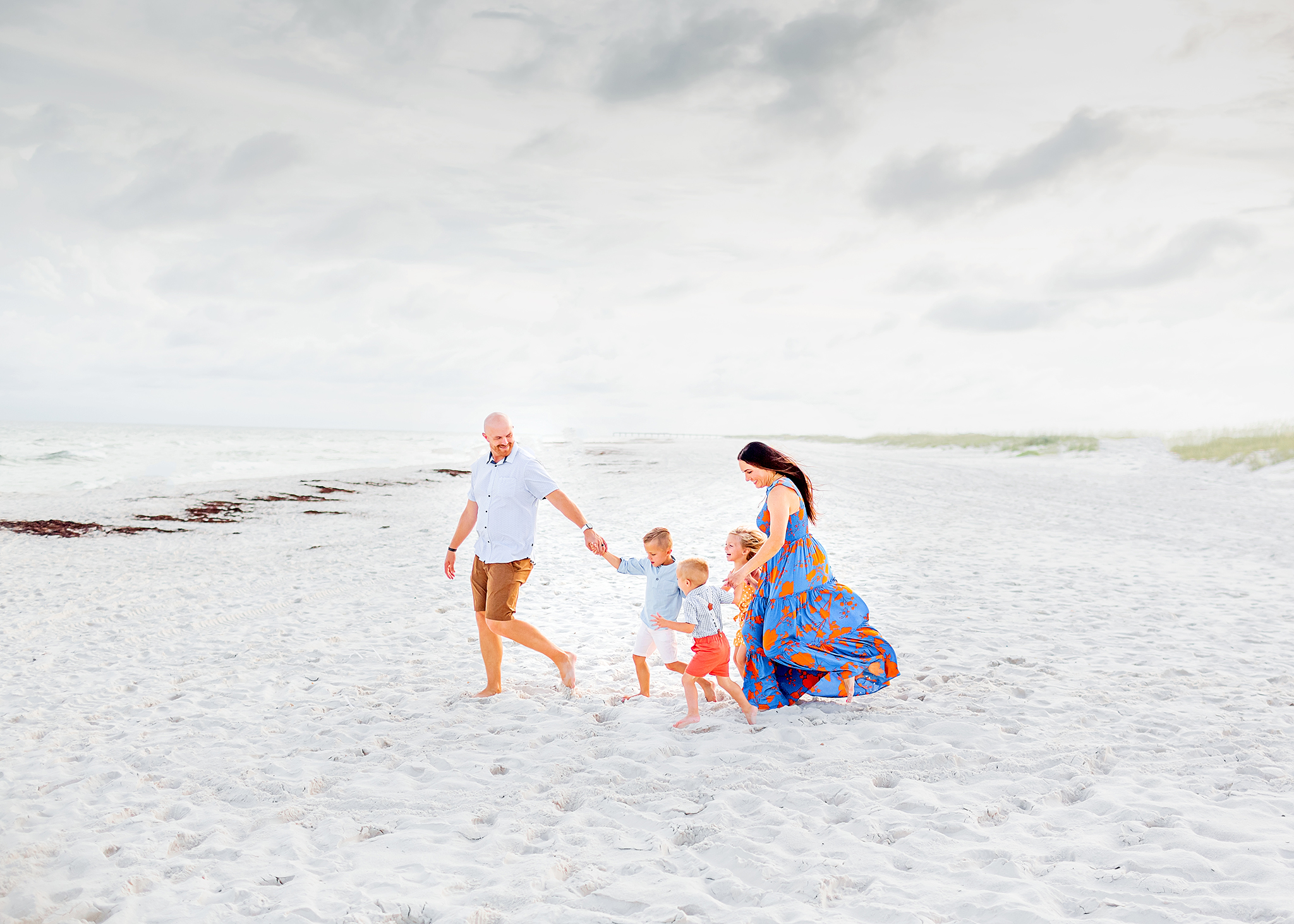 family walking on the beach captures by gulf shores photographer