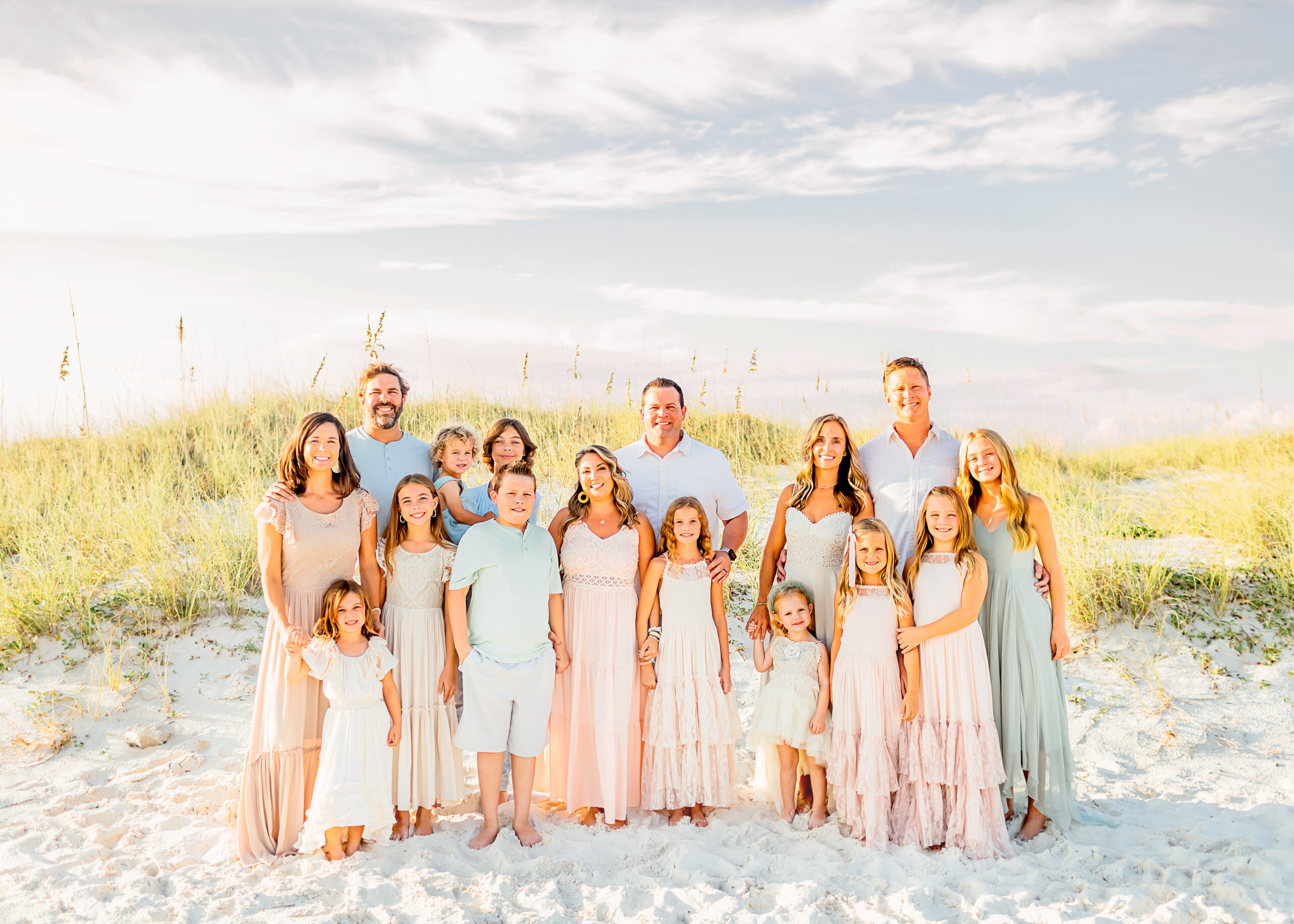 Large family group poses for photos on the beach of gulf shores captured by local photographer