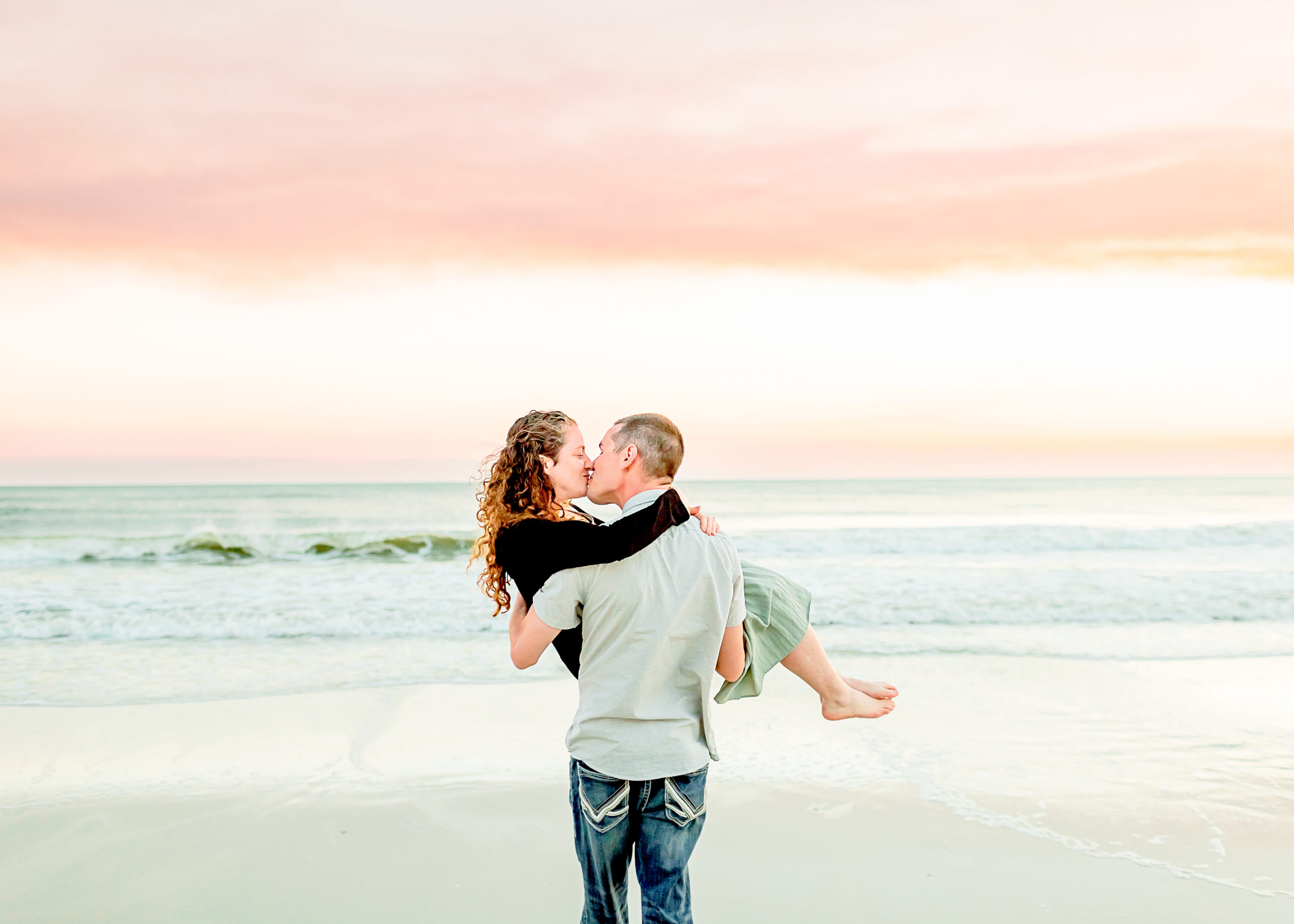Gulf Shores Engagement Photographer captures beautiful photo of newly engaged couple strolling the beach